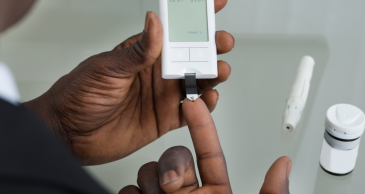 man testing blood glucose